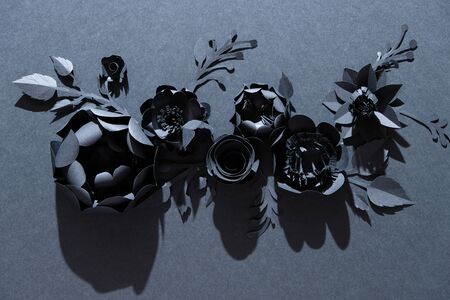 Black paper flowers on Black background. Cut from paper. Gothic frame. Total black. BLack friday...