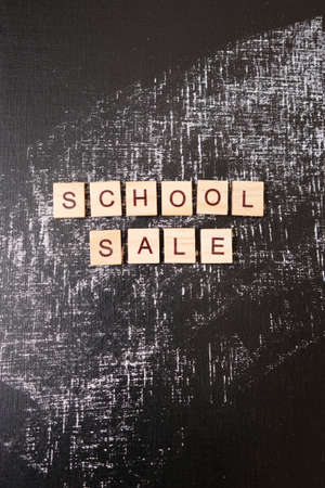 School sale with trendy shadow and different supplies on blackboard. Lettering school sale are made...