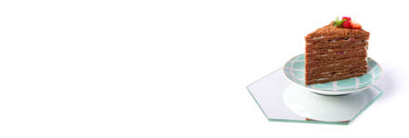 The piece of chocolate cake on white plate. A homemade cake slice. Long format for web