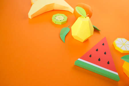 Exotic fruits made of paper on a bold orange background. Summer concept.の写真素材