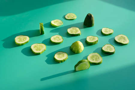 Composition with slices of cucumber on color backgroundの写真素材