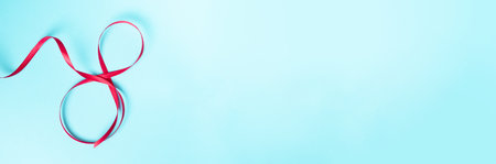 Red gift celebration ribbon in 8 digit shape. Happy womans dayの写真素材