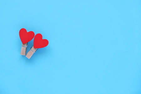 Happy Valentines day. Two wooden hearts on blue background