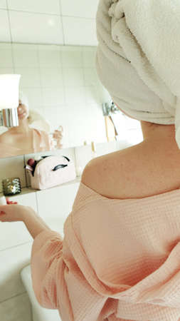 a girl takes care of herself in the bathroomの写真素材