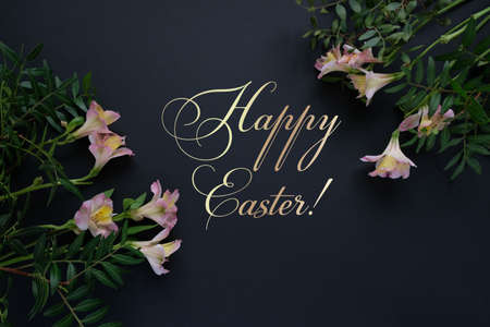 Luxury black easter eggs with gold pattern and pink flowers on black background. Happy easter