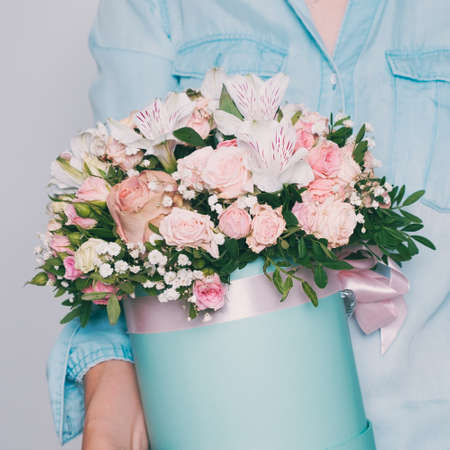 A bouquet of flowers in the hands of a woman