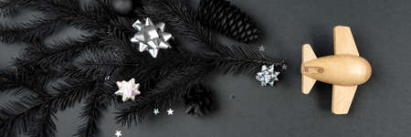 Happy new year and Merry Christmas. Wooden childrens plane on a black backgroundの写真素材