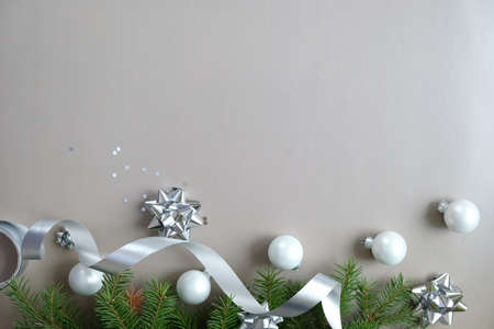 Happy new year and Merry Christmas. Background of Christmas tree branches with silver elements on...