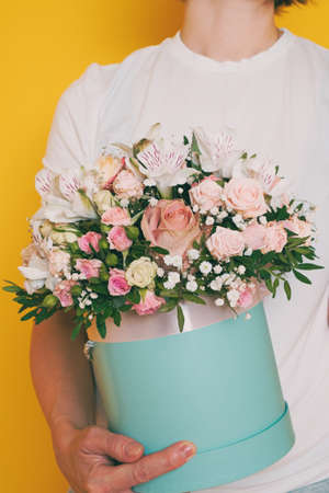 A bouquet of flowers in the hands of a womanの写真素材