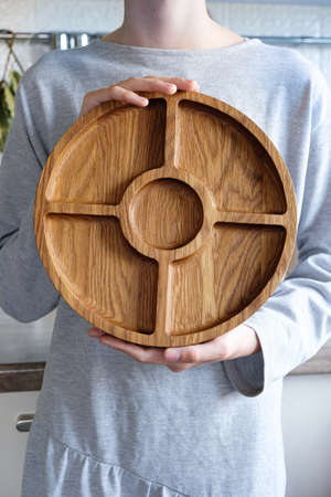 Wooden round menagerie in womens handsの写真素材