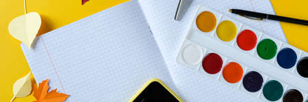 Back to school concept. Overhead shot of school supplies on yellow background. 1 september. long format for webの写真素材