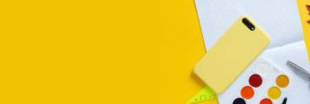 Back to school concept. Overhead shot of school supplies on yellow background. 1 september. long format for webの写真素材