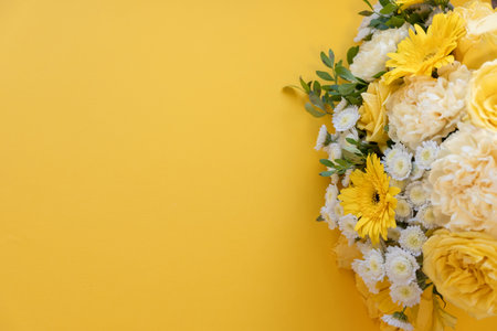 Bouquet of white and yellow flowers on a yellow backgroundの写真素材