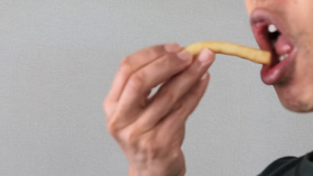 Person eating french friesの写真素材