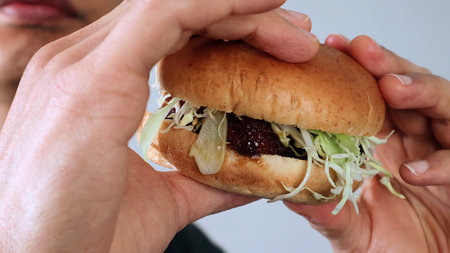 person holding a hamburgerの写真素材