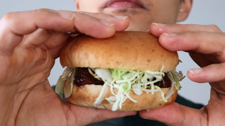 person holding a hamburgerの写真素材