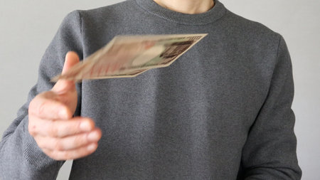 Person throwing banknotes