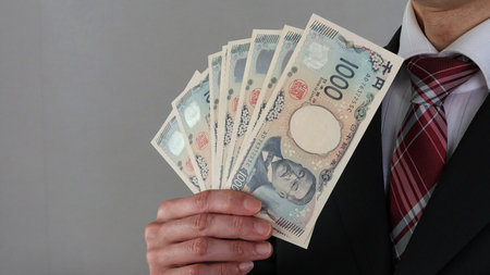 Businessman holding the new Japanese 1,000 yen bill