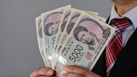 Businessman holding Japan's new 5,000 yen bill