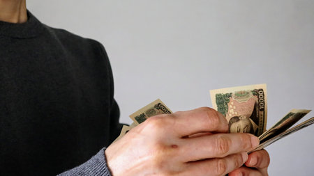 Person counting banknotesの写真素材