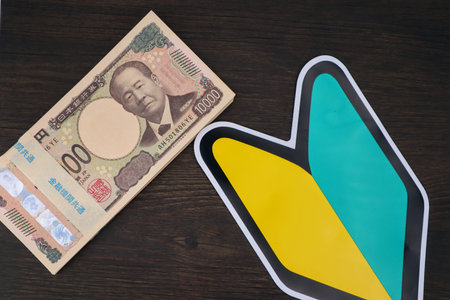 Japanese beginner's mark and stack of billsの写真素材