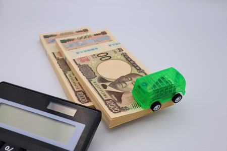 Car, stack of bills and calculatorの写真素材