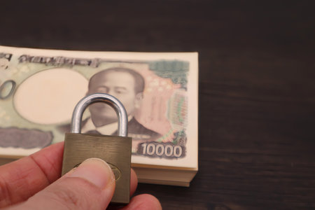 Close-up of a person holding a padlockの写真素材