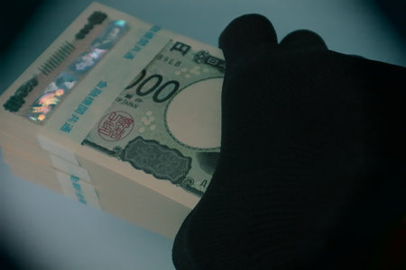 Close-up of a person holding a stack of billsの写真素材