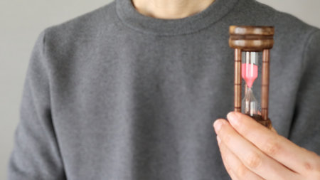 Person holding an hourglass