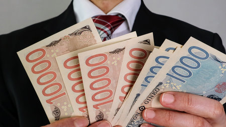 Close-up of businessman holding banknotesの写真素材