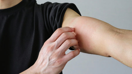 Close-up of a person scratching their skin