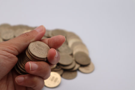 Person holding a 500 yen coinの写真素材