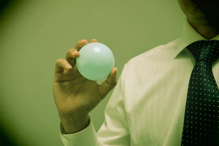 Close-up of a person holding a ball. Please write text on the ball.の写真素材