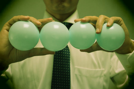 Close-up of a person holding a ball. Please write text on the ball.の写真素材