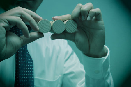 A person holding a building block. Please write your favorite letters on the building blocks.の写真素材