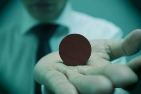 A person holding a wooden object. Please write your favorite letters on the object.の写真素材