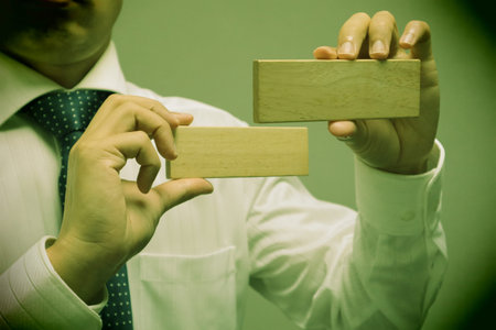 A person holding a building block. Please write your favorite letters on the building blocks.の写真素材