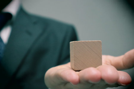 A person holding a building block. Please write your favorite letters on the building blocks.の写真素材