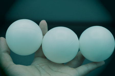 Close-up of a person holding a ball. Please write text on the ball.の写真素材