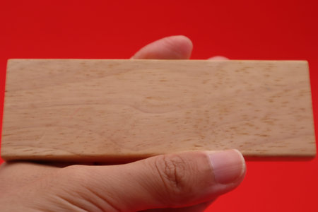 A person holding a building block.