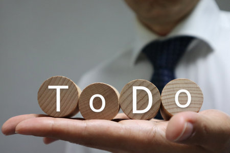 A person holding a building block with the word ToDo written on it