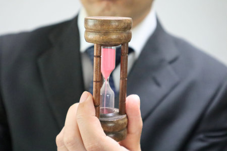 Businessman holding an hourglass