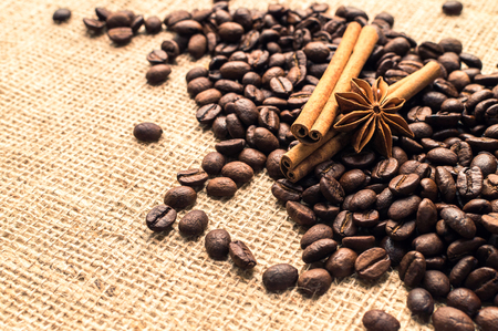 Coffee beans with cinnamon and anise on the sackcloth. Horizontalの写真素材