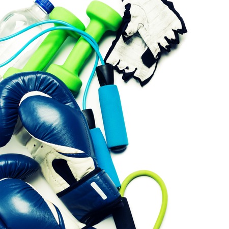 Fitness concept - boxing glove, dumbbells, skipping rope and bottle on the white backgroundの写真素材