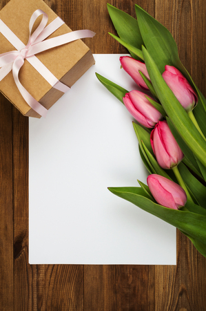 Pink tulips and white paper. Mother's Day. Spring flowers.の写真素材