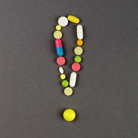 Exclamation point created from colored pills. Medical concept.の写真素材