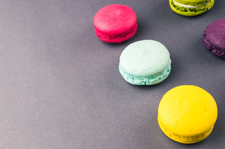 Colourful french macaroons on the grey background.の写真素材