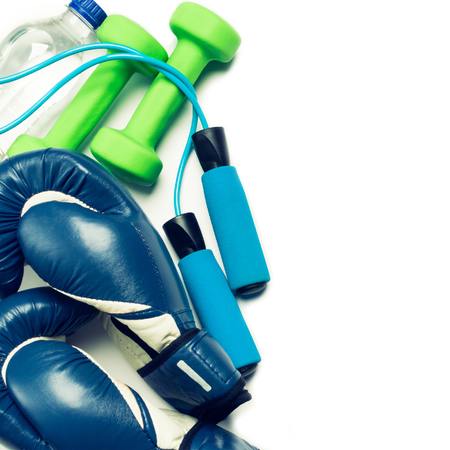 Fitness concept - boxing glove, dumbbells, skipping rope and bottle on the white backgroundの写真素材