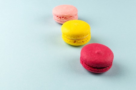 Colourful french macaroons on the grey background.の写真素材