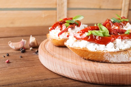 Italian sandwiches - bruschetta with cheese, tomato and basil.の写真素材